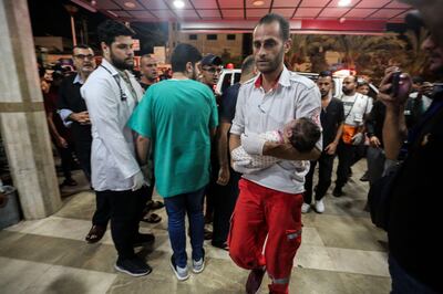 Palestinians injured in Israeli air strikes arrive at Al Nasr Hospital, in Khan Younis. Getty Images
