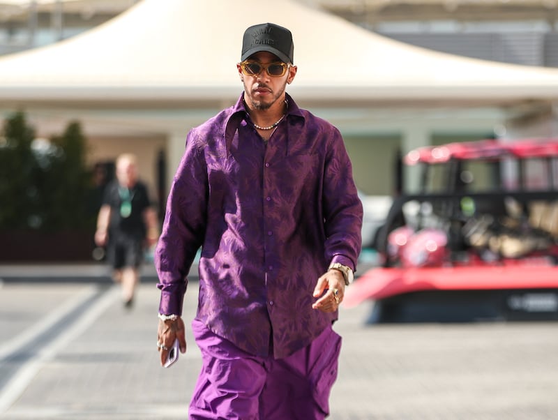 Lewis Hamilton, in a purple floral shirt and matching trousers, arrives at Yas Marina Circuit for Abu Dhabi Grand Prix on November 17, 2022. Victor Besa / The National