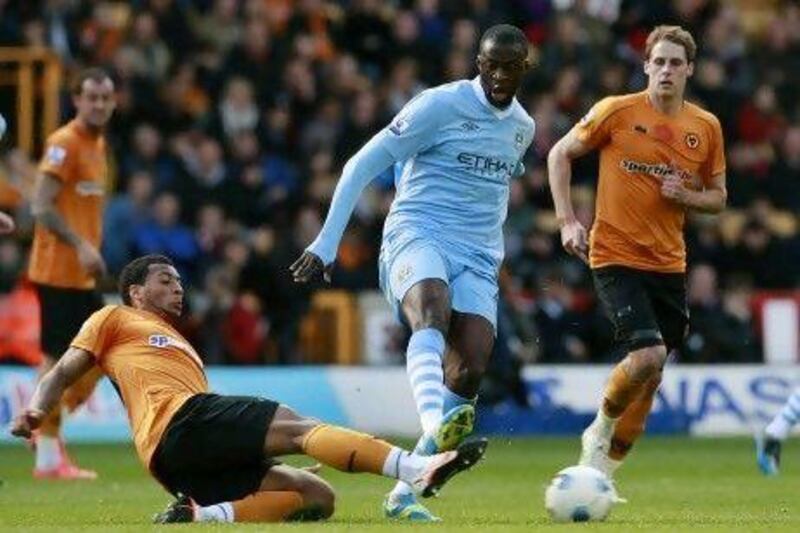 Yaya Toure, in blue, was all praise for his Manchester City teammates for beating Wolverhampton Wanderers. Tim Hales / AP Photo