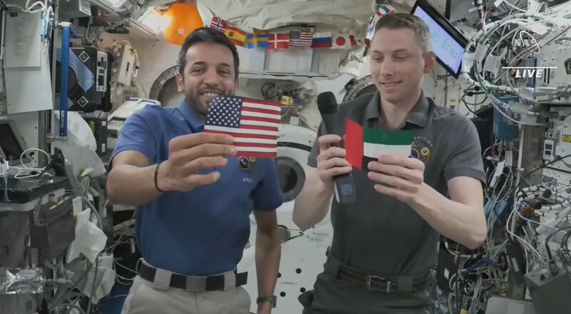 UAE astronaut Sultan Al Neyadi and Nasa's Woody Hoburg hold up the Emirati and US flags aboard the International Space Station. Photo: Nasa TV