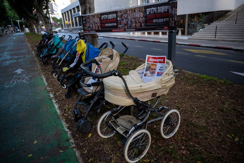 An art installation of prams with the faces of kidnapped children on display in Tel Aviv.  Getty Images
