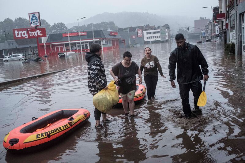 Rubber dinghies come in handy after the River Meuse burst its banks in Liege, Belgium..