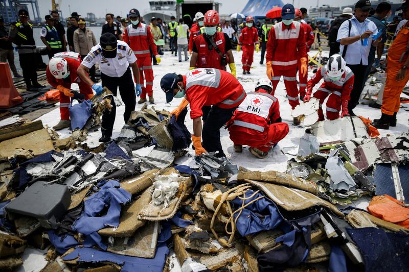 Indonesian rescuers sort recovered debris.