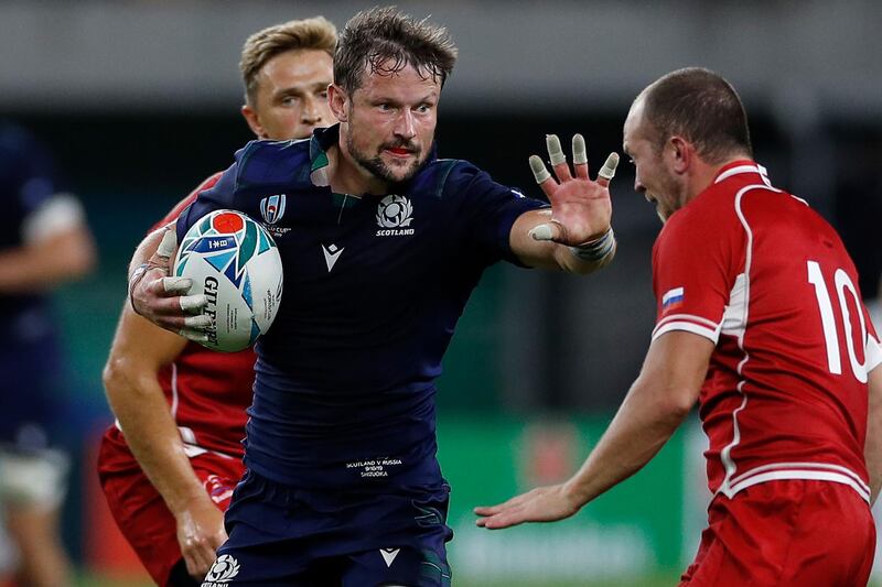 Scotland's centre Peter Horne (C) fends off a tackle by Russia's fly-half Ramil Gaisin (R) during the Japan 2019 Rugby World Cup Pool A match between Scotland and Russia at the Shizuoka Stadium Ecopa in Shizuoka. AFP