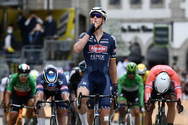 Stage winner Team Alpecin Fenix's Tim Merlier of Belgium celebrates as he crosses the finish line. AFP