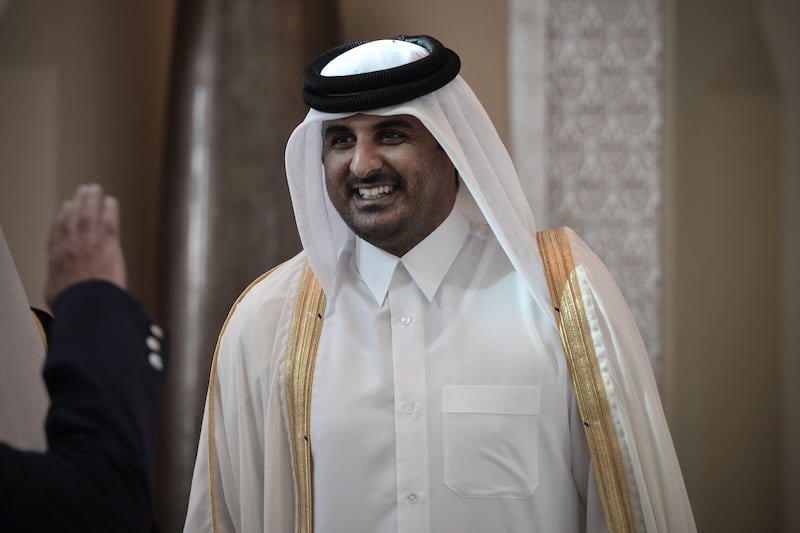(FILES)- A December 24, 2012, file photo shows Qatari Crown Prince Sheikh Tamim bin Hamad al-Thani smiling as he arrives in the Bahraini capital of Manama, to attend the annual Gulf Cooperation Council (GCC) summit. The Emir of Qatar, Sheikh Hamad bin Khalifa al-Thani, is expected to meet members of the royal family on June 24, 2013, with Qatari officials and diplomats saying a transfer of power to his son, Crown Prince Sheikh Tamim bin Hamad al-Thani, is imminent.  AFP PHOTO / MOHAMMED AL-SHAIKH
 *** Local Caption ***  412451-01-08.jpg