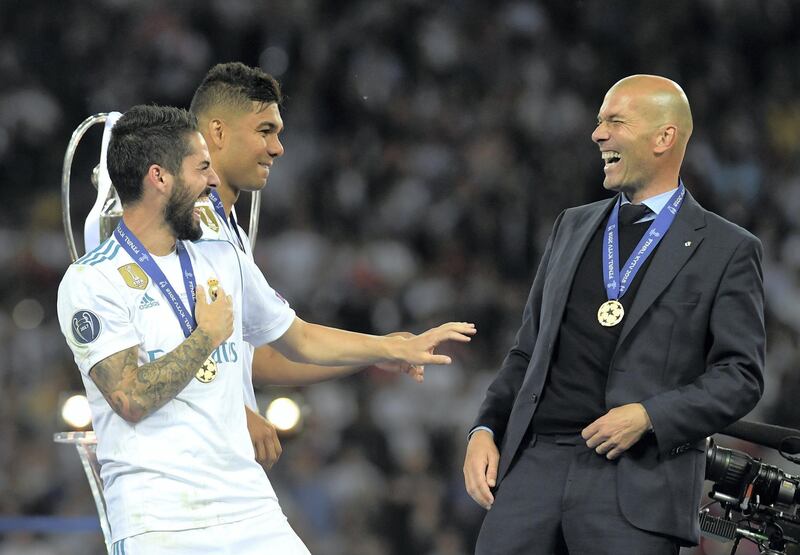 KIEV, UKRAINE - MAY 26:  Isco of Real Madrid speaks with Zinedine Zidane, Manager of Real Madrid following their sides victory in the UEFA Champions League Final between Real Madrid and Liverpool at NSC Olimpiyskiy Stadium on May 26, 2018 in Kiev, Ukraine.  (Photo by David Ramos/Getty Images)