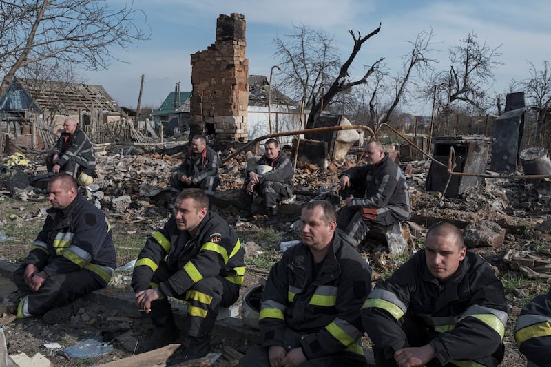 Firefighters take a rest after working at the site of buildings that were destroyed by shelling, amid Russia's invasion of Ukraine in Borodyanka, in the Kyiv region, Ukraine. Reuters