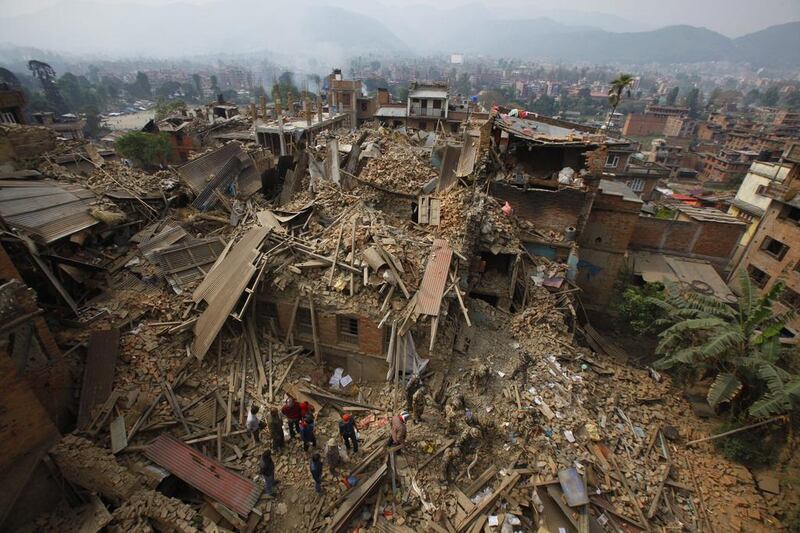 Rescue workers remove debris as they search for victims of earthquake in Bhaktapur near Kathmandu, Nepal, Sunday, April 26, 2015. A strong magnitude earthquake shook Nepal’s capital and the densely populated Kathmandu Valley before noon on Saturday, causing extensive damage with toppled walls and collapsed buildings, officials said. Niranjan Shrestha / AP Photo