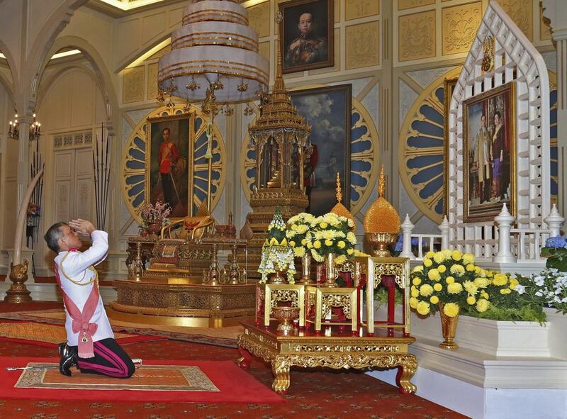 In Thailand ‘s new king Maha Vajiralongkorn Bodindradebayavarangkun pays his respects to a portrait of his late father king Bhumibol Adulyadej and Queen Sirikit at the Dusit Palace in Bangkok on December 1, 2016. Bureau of the Royal Household via AP