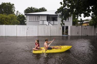 epaselect epa07337693 Nosh and Charlotte Talbot paddle down Queens Road during flooding in Rosslea, Townsville, Queensland, Australia, 02 February 2019. Thousands of residents downstream from the Ross River dam were evacuated after flash floods hit the region following heavy rains, media reported. EPA/ANDREW RANKIN AUSTRALIA AND NEW ZEALAND OUT