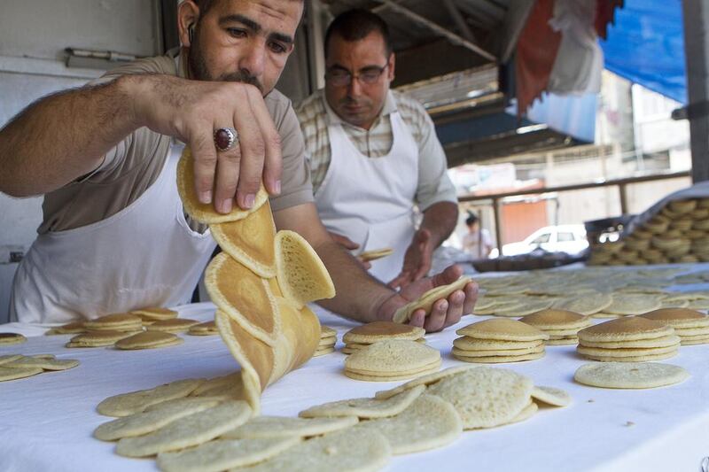 Essam (left) and Achmed Nimer at the Abu Ramadan for Sweets bakery in Gaza City on July 14. Despite the conflict they open their shop to sell their traditional Ramadan qatayef. Heidi Levine for The National