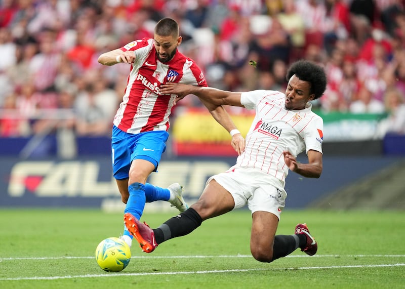 Atletico Madrid forward Yannick Ferreira Carrasco attempts to skip a challenge from Sevilla defender Jules Kounde. Getty
