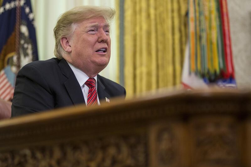 U.S. President Donald Trump addresses U.S. armed forces members on a Christmas Day video conference call in the Oval Office at the White House in Washington, D.C., U.S., on Tuesday, Dec. 25, 2018. Trump expressed confidence in the Treasury secretary, Federal Reserve and U.S. economy on Tuesday, moving to calm financial markets further roiled after Bloomberg News reported that the president had discussed firing the central bank’s chairman over raising interest rates. Photographer: Zach Gibson/Bloomberg