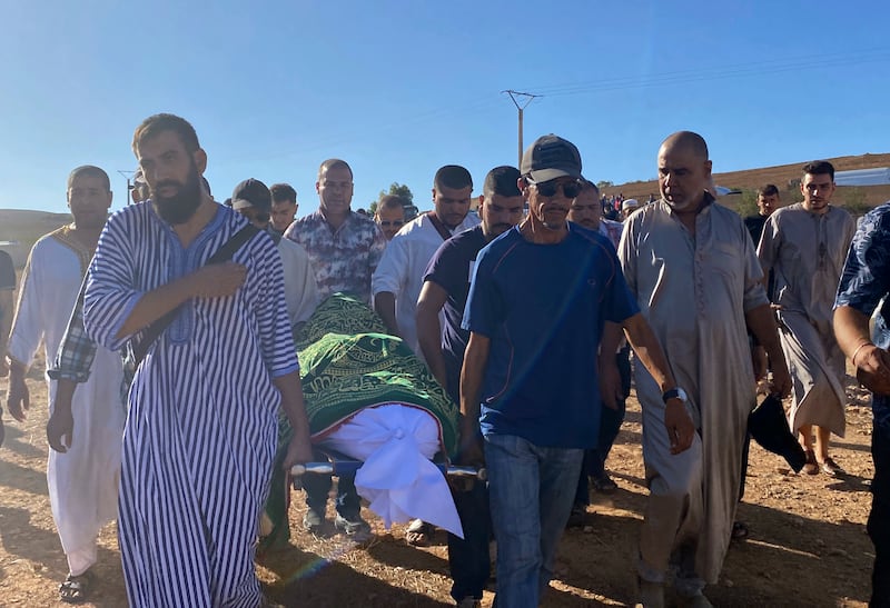 People attend the funeral of Bilal Kissi, who was killed by Algerian forces when he strayed over the sea border with Algeria. AP