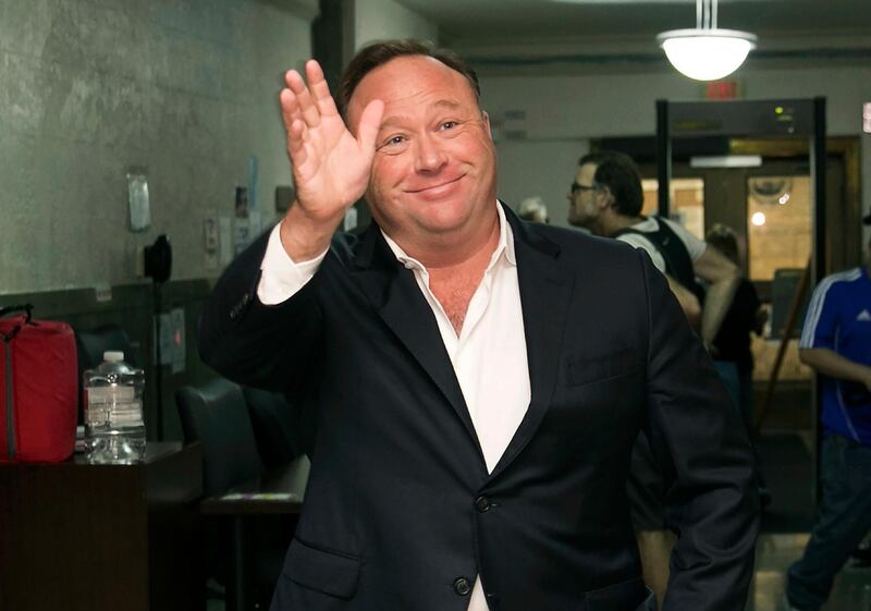 FILE - In this April 19, 2017, file photo, Alex Jones, a right-wing radio host and conspiracy theorist, arrives at the courthouse in Austin, Texas. Twitter says it is suspending the account of the far-right conspiracy theorist Alex Jones for one week after he violated the companyâ€™s rules against inciting violence. (Jay Janner/Austin American-Statesman via AP, File)