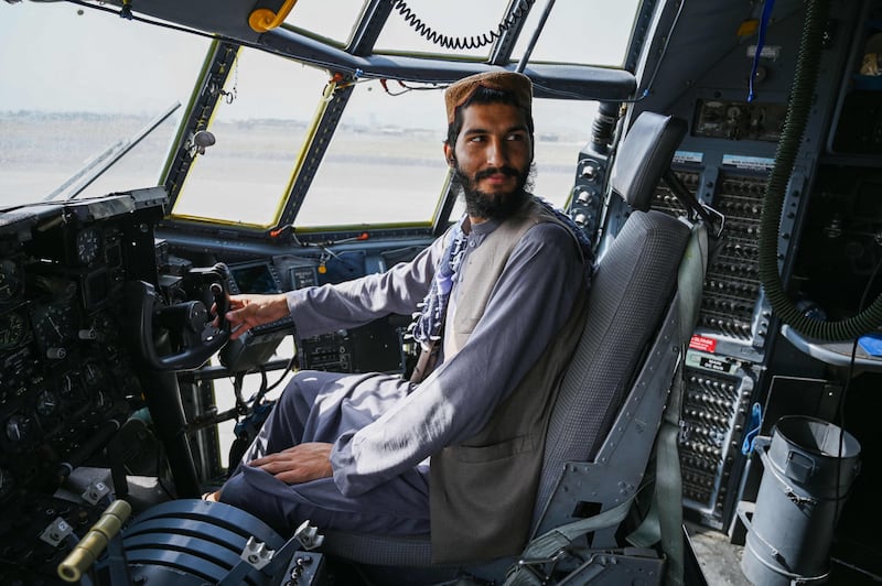 A Taliban fighter sits inside the cockpit of an Afghan Air Force aircraft. AFP