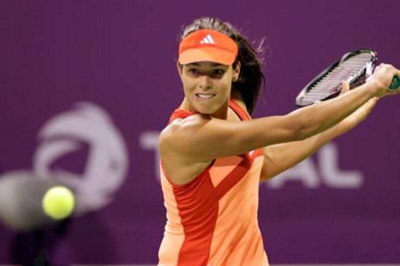 Ana Ivanovic of Serbia returns the ball to Carla Suarez Navarro of Spain during their Qatar Open tennis tournament in Doha February 13, 2012. REUTERS/Fadi Al-Assaad (QATAR - Tags: SPORT TENNIS) *** Local Caption ***  QAT34_TENNIS-WOMEN-_0213_11.JPG
