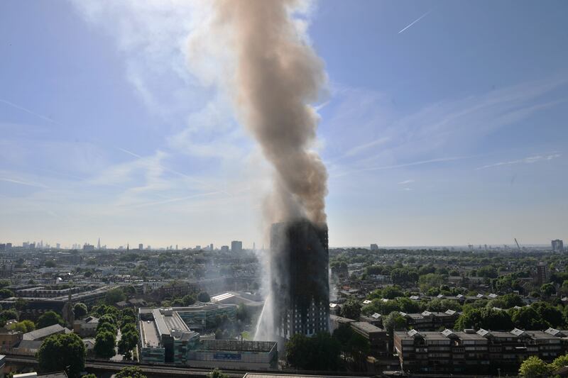 Smoke billowing from the fire that engulfed the 24-storey building. PA