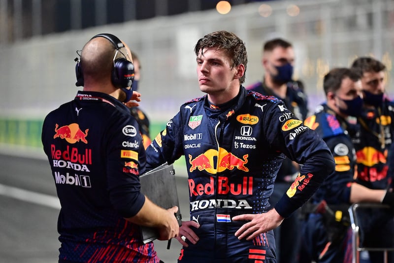 Red Bull driver Max Verstappen speaks with team members  during a second stop in the race. AFP