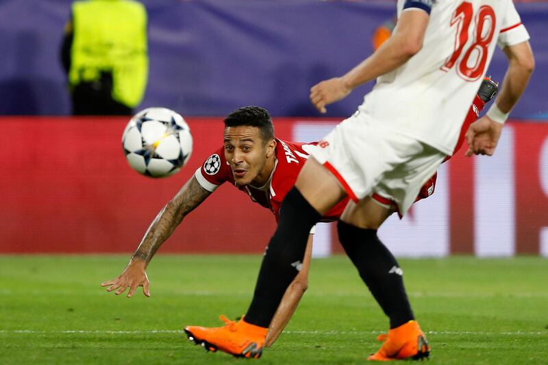Bayern's Thiago, background, scores his side's second goal behind Sevilla's Sergio Escudero during the Champions League quarter final first leg soccer match between Sevilla FC and FC Bayern Munich at the Sanchez Pizjuan stadium in Seville, Spain, Tuesday, April 3, 2018. (AP Photo/Miguel Morenatti)