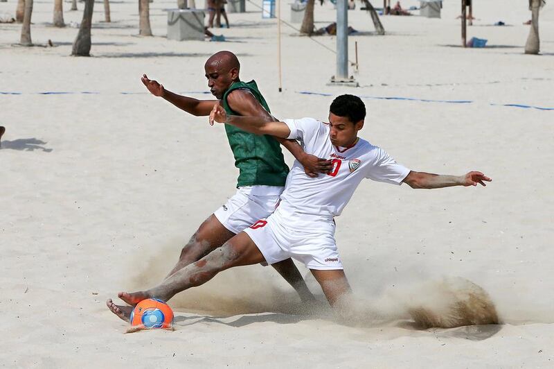 The national team player Buti Abdul Hussain, in white, trains at Al Mamzar Beach Park in Dubai last week. Pawan Singh / The National