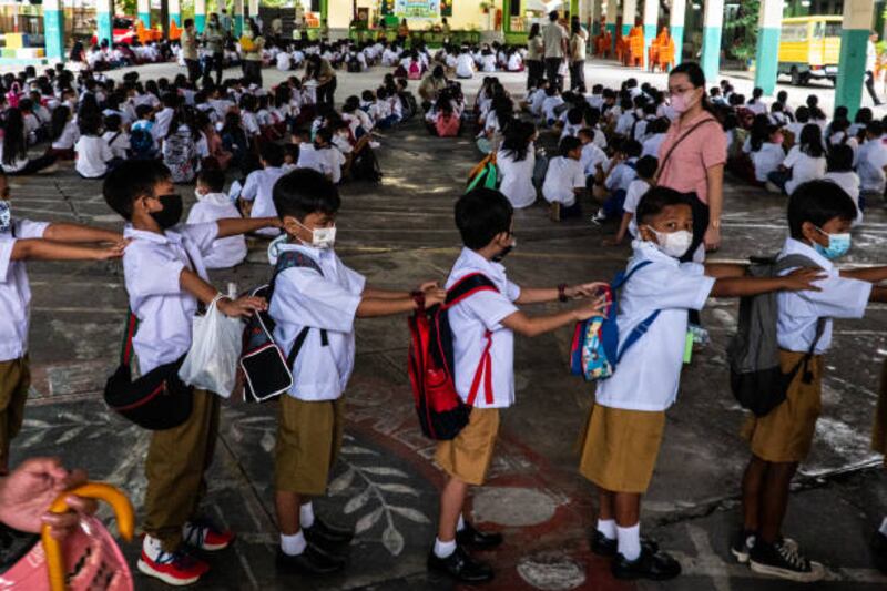 Pupils wait to enter their classrooms. Getty Images