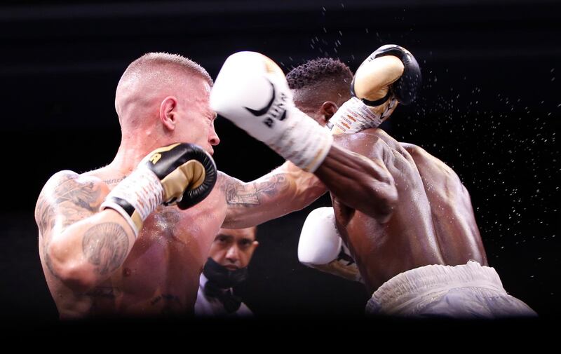 Anthony de Bruijn and Emmanuel Noi Mensah slug it out at close quarters in Dubai. EPA