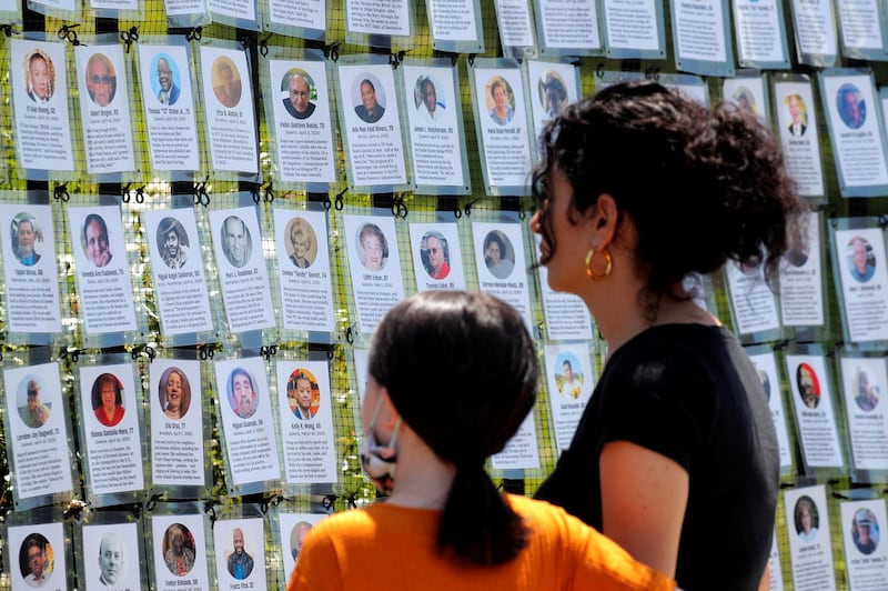 A woman and child look at the "Naming the Lost Memorials," as the U.S. deaths from the coronavirus disease (COVID-19) are expected to surpass 600,000, at The Green-Wood Cemetery in Brooklyn, New York, U.S., June 10, 2021. REUTERS/Brendan McDermid