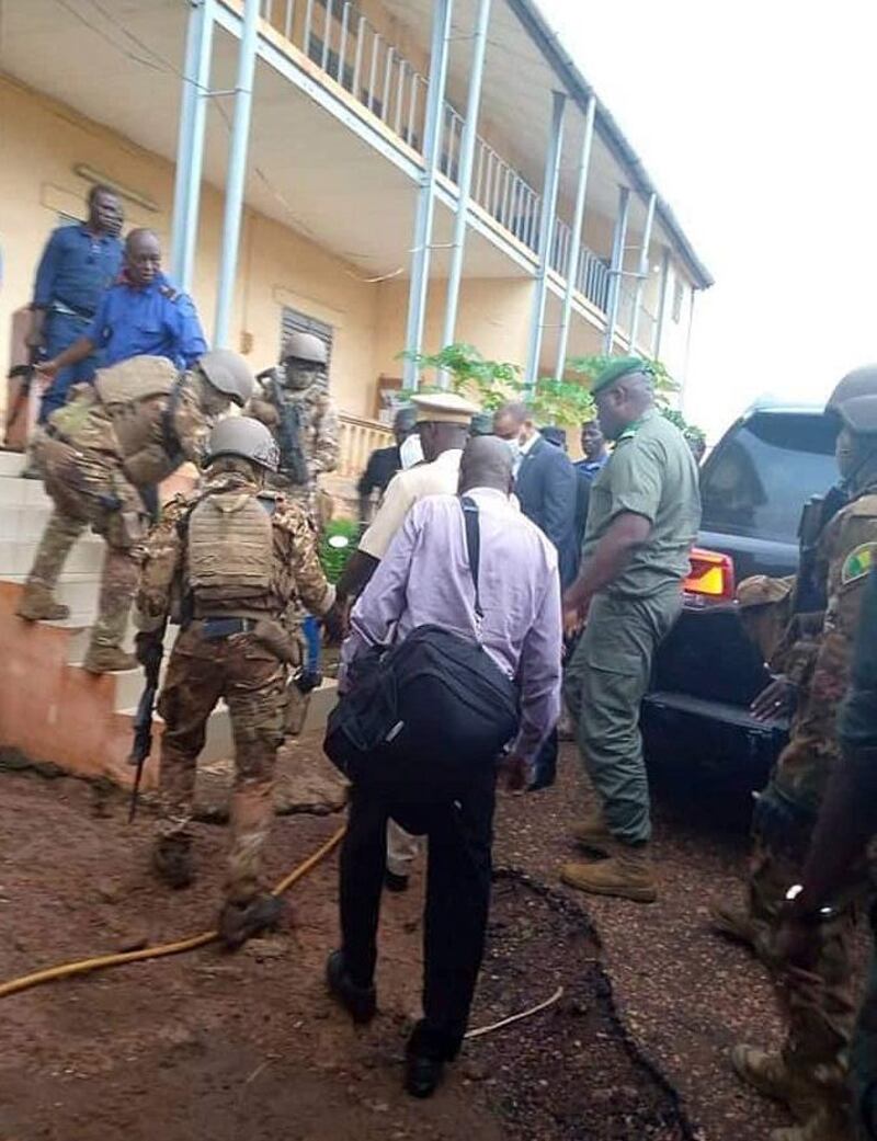 Malian military lead Mali President Ibrahim Boubakar Keita into a military house after he was seized in Bamako, Mali.  EPA