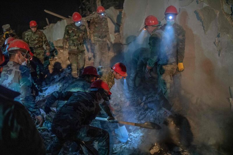 Rescue teams sift through rubble at a site hit by a rocket during fighting over the breakaway region of Nagorno-Karabakh, in the city of Ganja. AFP