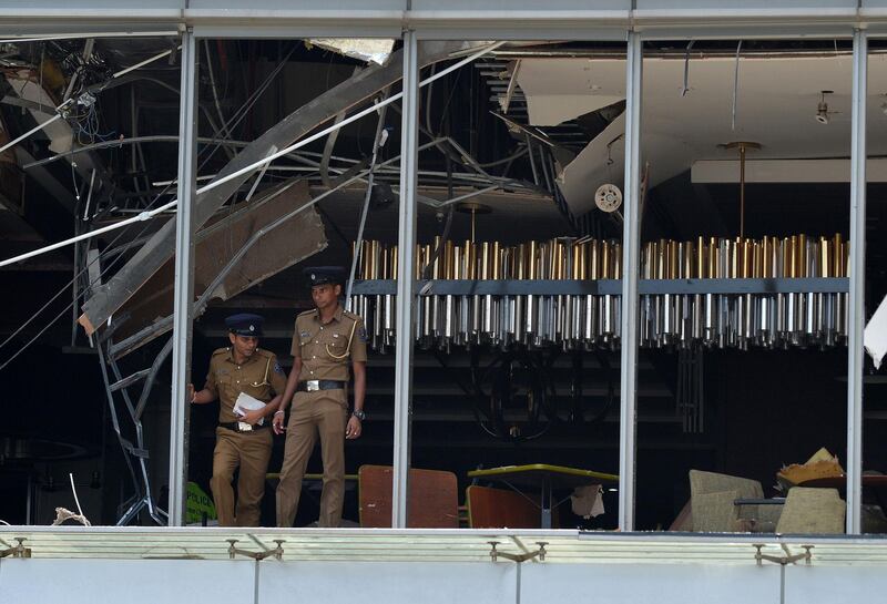 Sri Lankan police inspect the Shangri-la Hotel blast.  AFP