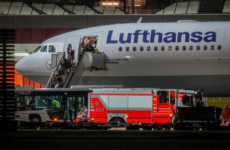 People disembark from a Lufthansa aircraft arriving from Tashkent, Uzbekistan, that landed in Frankfurt, Germany. On board were about 130 people that were evacuated from Afghanistan.