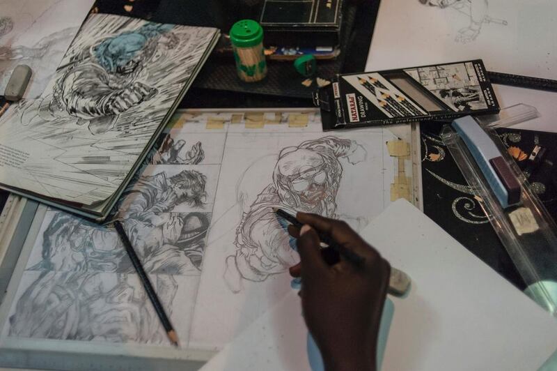An illustrator works on a sketch at the Comic Republic office in Lagos. Stefan Heunis / AFP