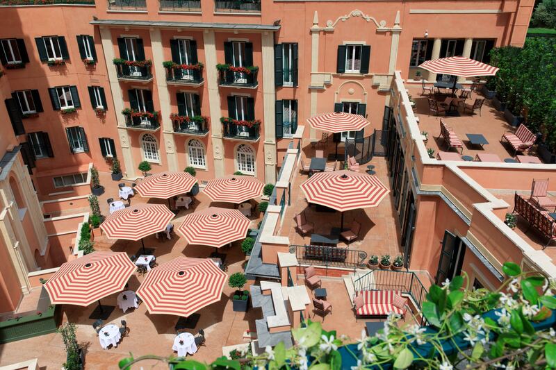 Terracotta colours and retro-striped parasols abound at Hotel De La Ville.