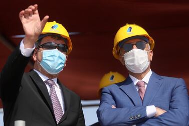 Iraqi oil minister Ihsan Abdul Jabbar gestures as he stands next to Iraq's Prime Minister Mustafa Al Kadhimi at the central station gas processing plant at Rumaila oilfield in Basra. Reuters