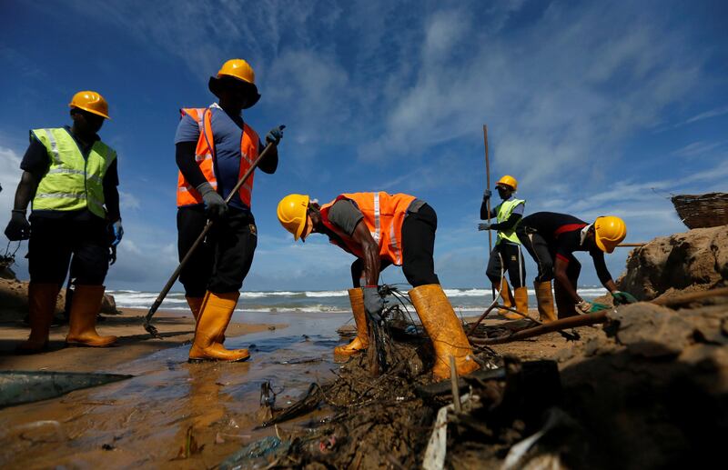 Workers collect garbage on a beach during' International Coastal Conservancy day' in Mount Lavinia, Sri Lanka. Dinuka Liyanawatte / AFP Photo