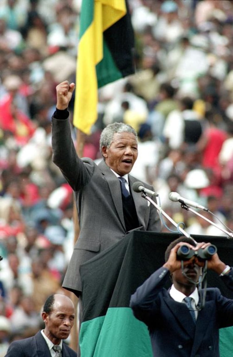 February. 13, 1990: Mandela salutes to 120,000 ANC supporters packing Soccer City stadium in the Soweto, shortly after his release from 27 years in prison. AP Photo