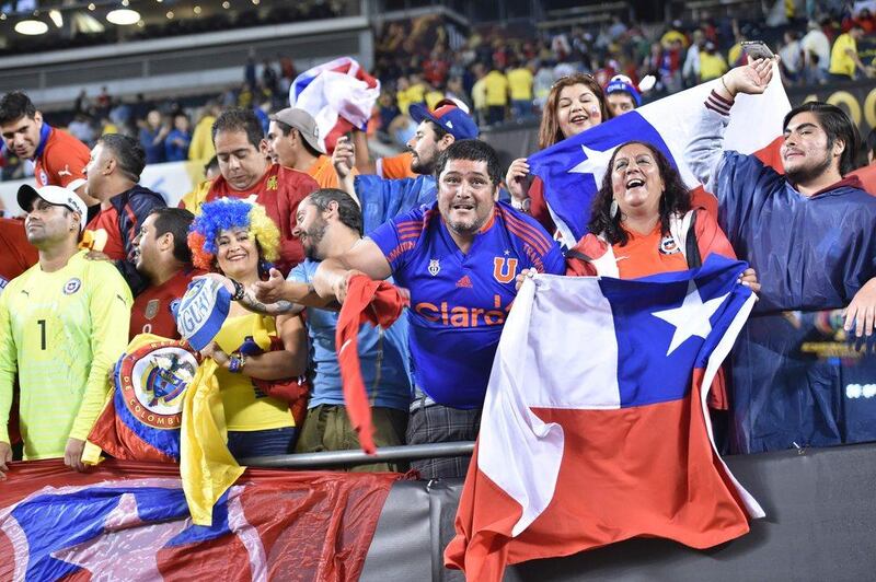 Fans of Chile cheer for their team at the end of the Copa America Centenario semifinal football match against Colombia, in Chicago, Illinois, United States, on June 22, 2016. / AFP / Nicholas Kamm
