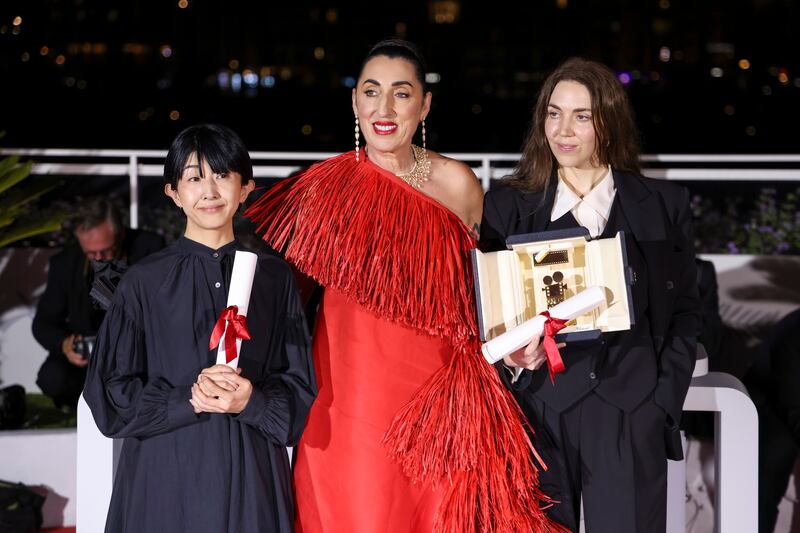 From left, Chie Hayakawa holds the Camera D'Or Special Distinction Award for 'Plan 75'; actress Rossy de Palma; and director Gina Gammell, winner of the Camera d'Or award in Un Certain Regard for 'War Pony', during the photocall following the awards ceremony at Cannes. AP