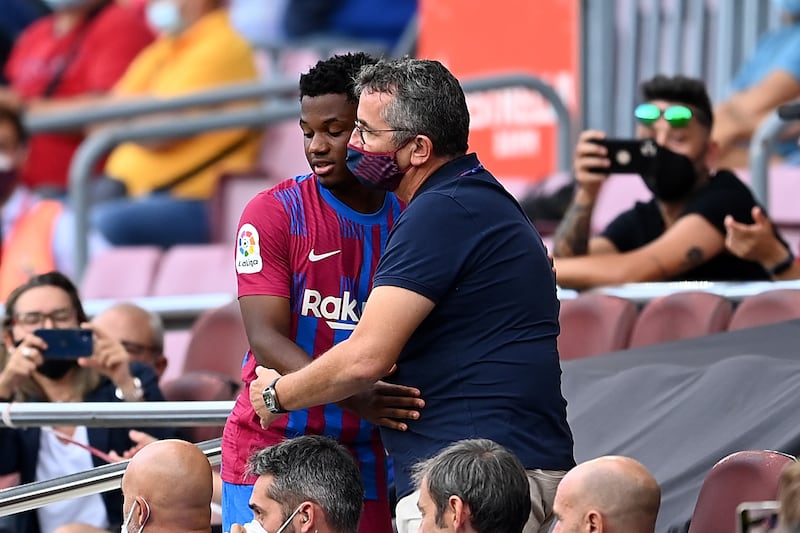 Ansu Fati of Barcelona hugs the club doctor. Getty Images