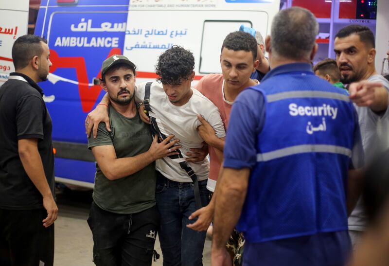 Injured Palestinians arrive at Nasser Hospital in the Gaza Strip, an enclave sealed off by Israel and hit by sustained retaliatory air strikes after the surprise Hamas attack. Getty Images