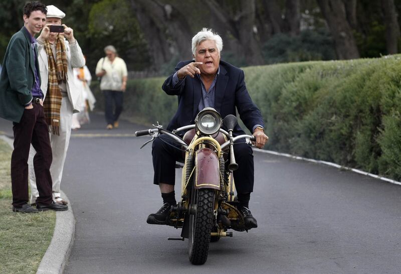 Leno rides a 1930 Bohmerland motorcycle at the Pebble Beach Golf Links. Reuters