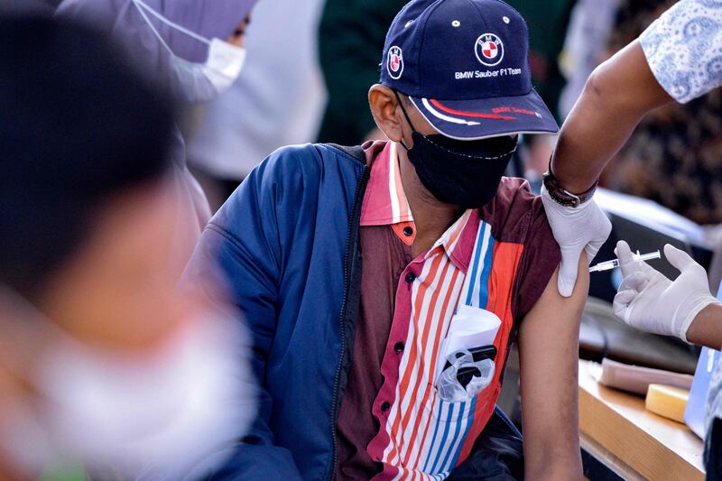 A man receives a dose of the Sinovac Covid-19 coronavirus vaccine at a convention hall building in Banda Aceh.