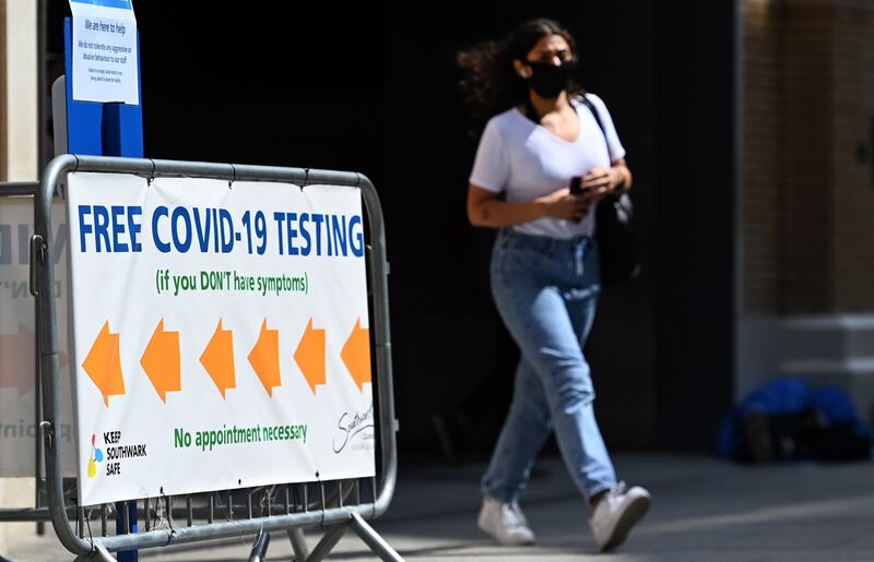 A pedestrian passes a Covid-19 test centre in London on August 4. EPA