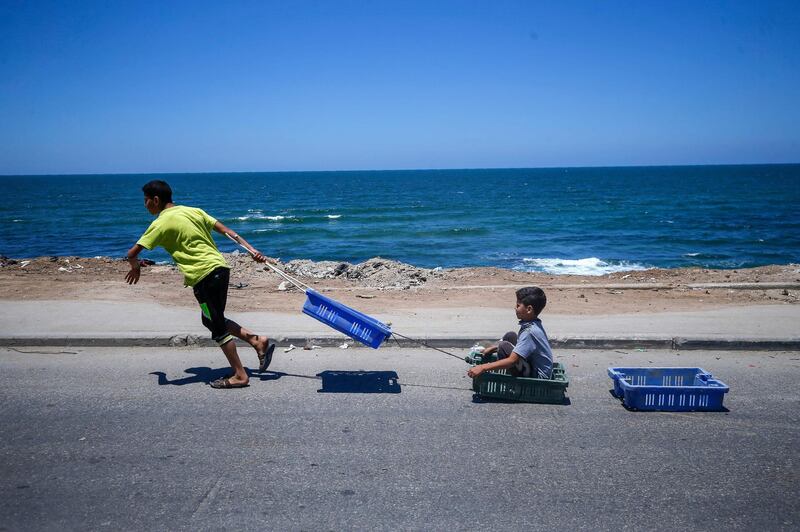 Young Palestinians play at the seashore in Gaza City amid the coronavirus pandemic.  AFP