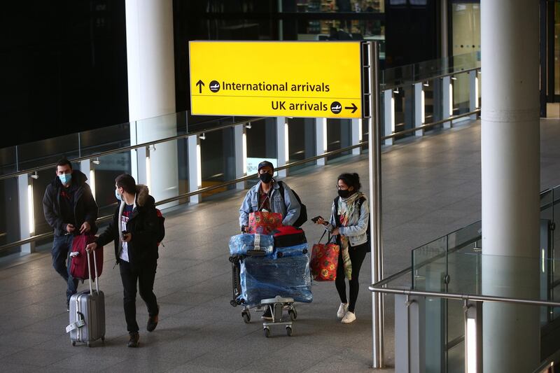 Travellers arrive at Heathrow Terminal 2 on January 30, after the UK added the UAE to the red list of countries banned from flying to Britain. Hollie Adams / Getty