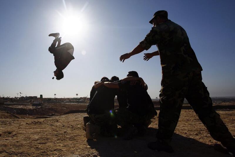 Fighters from the Iraqi Imam Ali Brigade take part in a training exercise in Iraq's central city of Najaf on March 7, 2015, ahead of joining the military operation to retake Tikrit. Haidar Hamdani/AFP Photo

