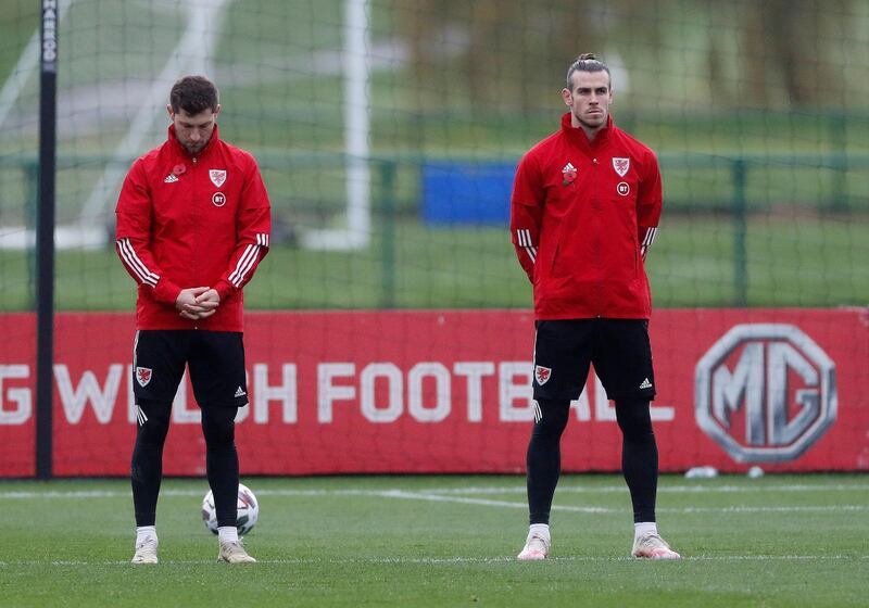 Wales' Gareth Bale and Ben Davies, left, observe a minute's silence as part of remembrance commemorations during training. Reuters