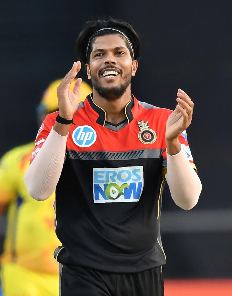 Royal Challengers Bangalore cricketer Umesh Yadav celebrates after taking the wicket of Chennai Super Kings batsman Suresh Raina during the 2018 Indian Premier League (IPL) Twenty20 cricket match between Chennai Super Kings and Royal Challengers Bangalore at the Maharashtra Cricket Association Stadium in Pune on May 5, 2018. / AFP PHOTO / PUNIT PARANJPE / ----IMAGE RESTRICTED TO EDITORIAL USE - STRICTLY NO COMMERCIAL USE----- / GETTYOUT